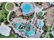 Aerial view of a resort-style community with multiple pools, water features, and well-maintained landscaping at 1454 Myrtlewood St, Davenport, FL 33896