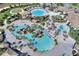 Stunning aerial view of a community center featuring pools, palm trees and meticulously maintained grounds at 1454 Myrtlewood St, Davenport, FL 33896