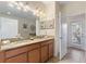 Bathroom featuring a double vanity with granite countertops, custom cabinetry, and tile flooring at 1454 Myrtlewood St, Davenport, FL 33896