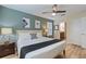 Bedroom with neutral walls, modern decor, bedside tables, and view to the en-suite bathroom at 1454 Myrtlewood St, Davenport, FL 33896