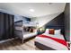 Stylish bedroom featuring a bunk bed, a queen bed with an orange blanket, and modern space-themed decor at 1454 Myrtlewood St, Davenport, FL 33896