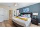 Charming bedroom with warm lighting, a decorative headboard, and access to an en-suite bathroom at 1454 Myrtlewood St, Davenport, FL 33896
