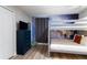 Well-organized bedroom featuring a bunk bed, a dresser, and a TV with themed decor at 1454 Myrtlewood St, Davenport, FL 33896