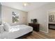 Bedroom with a window, queen-sized bed, wood-look floors, and access to the en suite bathroom at 1454 Myrtlewood St, Davenport, FL 33896