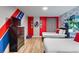 A themed bedroom with wood floors, a dresser, a tv, and two beds, decorated with the Avengers and Hulk at 1454 Myrtlewood St, Davenport, FL 33896