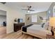 Bright bedroom with ceiling fan, dresser, and a comfortable bed with stylish accents at 1454 Myrtlewood St, Davenport, FL 33896