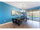 Bright dining room featuring a dark wood table with seating for six and pool view at 1454 Myrtlewood St, Davenport, FL 33896