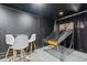 A game room features a basketball game setup with a net, a small table, and chairs for spectators to enjoy the competition at 1454 Myrtlewood St, Davenport, FL 33896
