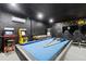 A game room equipped with a pool table, arcade games, a bubble hockey game, and gaming chairs for an entertaining experience at 1454 Myrtlewood St, Davenport, FL 33896