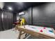 Features classic arcade games and a bubble hockey table in a game room, offering various entertainment options for residents at 1454 Myrtlewood St, Davenport, FL 33896