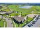 Scenic aerial view of a golf course community featuring a lake, clubhouse, and lush green landscape at 1454 Myrtlewood St, Davenport, FL 33896