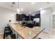 Kitchen featuring granite countertops, stainless appliances, and breakfast bar seating at 1454 Myrtlewood St, Davenport, FL 33896