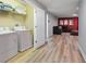 Spacious laundry room featuring a washer, dryer, and a convenient folding area next to a cozy living space at 1454 Myrtlewood St, Davenport, FL 33896