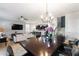 Open-concept living and dining area featuring tiled floors, modern lighting, and comfortable seating at 1454 Myrtlewood St, Davenport, FL 33896