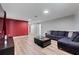 Spacious living room with wood flooring, stylish furniture and modern lighting fixtures at 1454 Myrtlewood St, Davenport, FL 33896