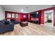 Comfortable living room with large TV, modern furniture, and a view of a beautifully decorated bedroom at 1454 Myrtlewood St, Davenport, FL 33896