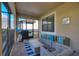 A covered patio features comfortable seating, a dining area, and a barbecue grill, perfect for outdoor living and entertaining at 1454 Myrtlewood St, Davenport, FL 33896