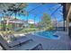Enjoy outdoor living with this screened-in pool area featuring a pool, patio, and lounge chairs at 1454 Myrtlewood St, Davenport, FL 33896