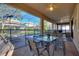 A pool patio features a dining area, seating options, lounge chairs, and a pool area enclosed by a safety fence at 1454 Myrtlewood St, Davenport, FL 33896
