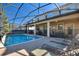 A luxurious pool featuring sun loungers, a covered patio, and a protective pool fence at 1454 Myrtlewood St, Davenport, FL 33896