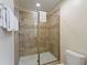 Modern shower with a glass door, tiled walls, and sleek fixtures for a spa-like experience at 1454 Myrtlewood St, Davenport, FL 33896