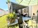 Cozy covered patio with pavers, hammock, and seating, creating a relaxing outdoor living space at 14945 Huntcliff Park Way, Orlando, FL 32824