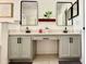 Beautiful bathroom with dual sinks, quartz countertops, sleek black fixtures, and framed mirrors at 14945 Huntcliff Park Way, Orlando, FL 32824