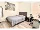 Cozy bedroom with laminate floors, a gray bed, and a modern city-themed art piece at 14945 Huntcliff Park Way, Orlando, FL 32824
