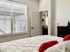 Bright bedroom with a large window and plush white bedding, creating a peaceful retreat at 14945 Huntcliff Park Way, Orlando, FL 32824