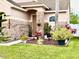 Charming home exterior featuring a brick facade, well-manicured landscaping, and a welcoming entrance at 14945 Huntcliff Park Way, Orlando, FL 32824