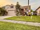 Charming single-Gathering home featuring a well-maintained lawn, landscaped garden and two-car garage at 14945 Huntcliff Park Way, Orlando, FL 32824