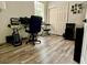 Functional home office space with wood laminate flooring, a computer, and a comfortable desk chair at 14945 Huntcliff Park Way, Orlando, FL 32824