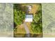 Aerial view of the home and large lot with tree coverage and a detached structure at 150 N Post Office Rd, Kenansville, FL 34739
