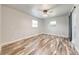 Bedroom features modern ceiling fan, windows, and sliding barn door at 150 N Post Office Rd, Kenansville, FL 34739