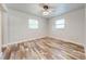 Bedroom with neutral walls, windows, and modern ceiling fan at 150 N Post Office Rd, Kenansville, FL 34739