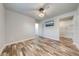 Bedroom with ceiling fan, walk-in closet, and view to hall at 150 N Post Office Rd, Kenansville, FL 34739