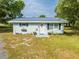Charming single-story home with a metal roof, fresh paint and decorative shutters at 150 N Post Office Rd, Kenansville, FL 34739