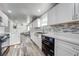 Bright kitchen with white cabinets, stainless steel appliances, and tile backsplash at 150 N Post Office Rd, Kenansville, FL 34739