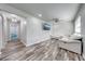 Open-concept living space with modern design and durable flooring at 150 N Post Office Rd, Kenansville, FL 34739