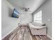 Bright living room features modern couches, hardwood floors, and a ceiling fan at 150 N Post Office Rd, Kenansville, FL 34739