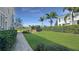 Spacious backyard featuring a lush green lawn, privacy hedges, and a charming fire pit area at 1506 Euston Dr, Reunion, FL 34747