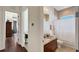 Bathroom features a wooden vanity with granite countertop, as well as tile shower at 1506 Euston Dr, Reunion, FL 34747