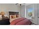 Cozy bedroom with window seat, plush bedding, and dark wood furniture at 1506 Euston Dr, Reunion, FL 34747