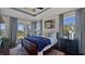 Comfortable bedroom with natural light, wood floors, and balcony access with outdoor views at 1506 Euston Dr, Reunion, FL 34747