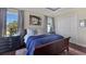 Cozy primary bedroom showcases wood floors, and two windows providing plenty of natural light at 1506 Euston Dr, Reunion, FL 34747