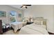 Bright bedroom with two twin beds, soft colors, side table and chair at 1506 Euston Dr, Reunion, FL 34747