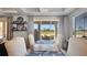 Open dining space with outdoor view, decorative shelving, and comfortable seating for a relaxed atmosphere at 1506 Euston Dr, Reunion, FL 34747