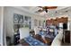 Bright dining area featuring a farmhouse table, island seating, and an open layout to the kitchen at 1506 Euston Dr, Reunion, FL 34747