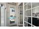 Bright entryway with sidelight, view of pool and spa, and access to home office with glass french doors at 1506 Euston Dr, Reunion, FL 34747