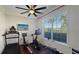 Home gym with a treadmill, stationary bike, weights, and natural light, creating an ideal workout space at 1506 Euston Dr, Reunion, FL 34747